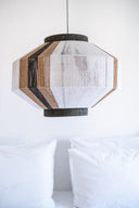 Handmade geometric pendant lamp made from sustainable paper threads in white, raw sienna, and black stripes - WADA NO.10 by Studio Ponce.