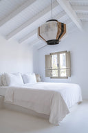 Handmade geometric pendant lamp made from sustainable paper threads in white, raw sienna, and black stripes - WADA NO.10 by Studio Ponce.